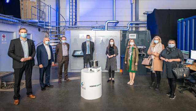 8 people standing and Sanna Marin Visits Soletair Power Factory